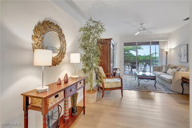 Living room featuring ceiling fan and light hardwo