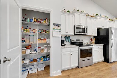 Kitchen with lofted ceiling, stainless steel appli