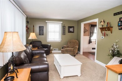 Living Room with newer carpet open to Kitchen/Dining area