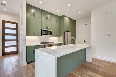 Kitchen with green cabinets, stainless steel appl