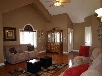 Vaulted family room w/ gleaming wood flo