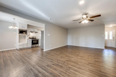Unfurnished living room with ceiling fan with nota