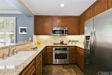 Open kitchen with granite counters, travertine bac