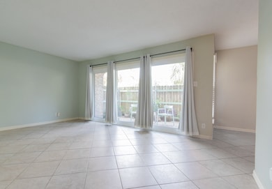 Living room with formal dining to the right. Patio