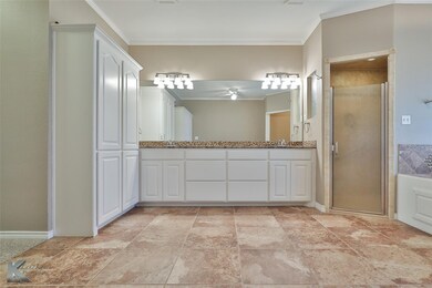 Bathroom featuring crown molding, vanity, and walk