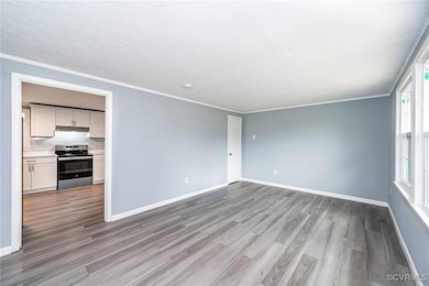Empty room with light hardwood / wood-style floori