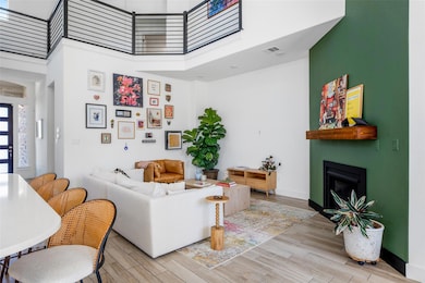 Living room featuring a high ceiling, a fireplace
