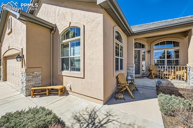 Entrance to property with a garage and covered fro