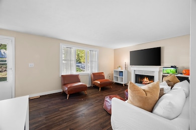 Living room w/ front entry & stairs to the left