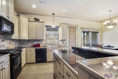 Lots of cabinetry with island and raiser bar.  Gra
