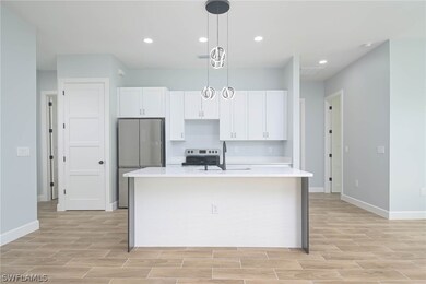 Kitchen featuring white cabinets, pendant lighting