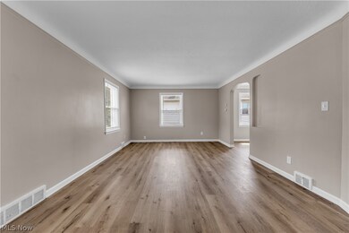 Unfurnished room featuring crown molding and hardwood / wood-style floors