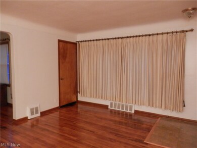 Living room with big window and hardwood
