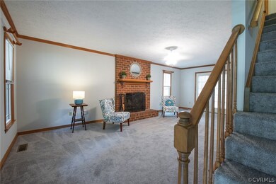 Great room with raised hearth brick fireplace.  Ne