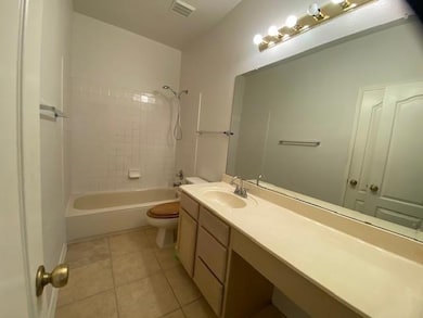Bathroom with vanity,  shower combination, and ti