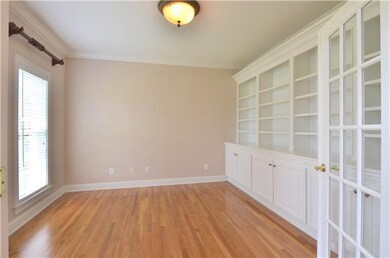 The formal living room has French doors and custom