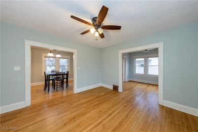 Unfurnished room featuring a textured ceiling, light wood-type flooring, and ceiling fan