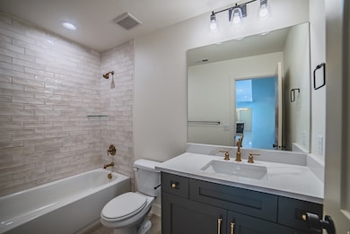 Full bathroom featuring shower / bathtub combination, vanity, and recessed lighting