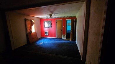 Spare room with heating unit, ceiling fan, and bas