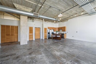 Garage featuring stainless steel fridge with ice dispenser and baseboards