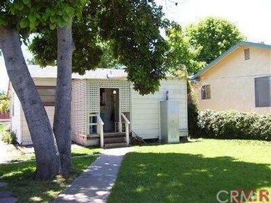 Back of front house with nice yard and huge avocad