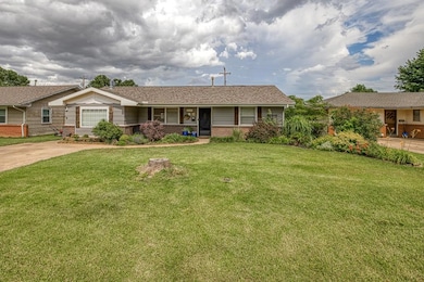 Ranch-style house with brick siding, a front lawn, and covered porch