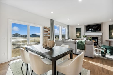 (Photo of decorated model, actual homes finishes will vary) Soaked in natural sunlight, the homes eat-in dining room has ample space for a dining table located in the heart of the home.