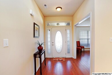 Inside view of the front door, foyer, and office entry. The flooring in the main living areas was upgraded to handscraped hardwood approximately 5 years ago.