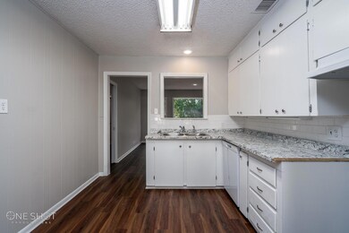 Kitchen with sink, a textured ceiling, white dishw