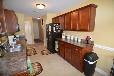Kitchen comes loaded with all major appliances and cherry cabinets.