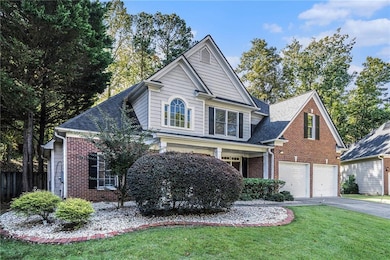 Traditional home with brick siding, driveway, covered porch, and a shingled roof