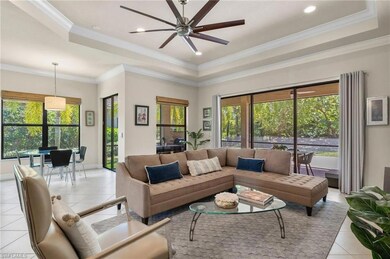 Tiled living room with a tray ceiling, crown moldi
