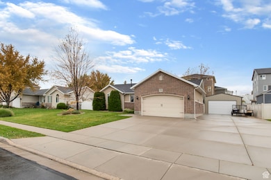 View of front of home with driveway, brick siding, and an attached garage
