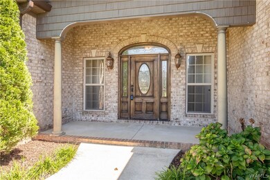 This larger front porch is covered and inviting wi