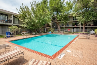 Community pool featuring a patio area and fence