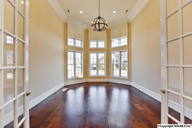 14' ceilings, front of house, hardwoods, french doors, pendant lighting.