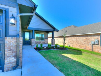 Doorway to property featuring brick siding, a yard, and a porch