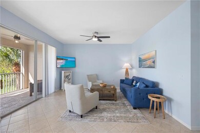 Living room with light tile patterned floors and c