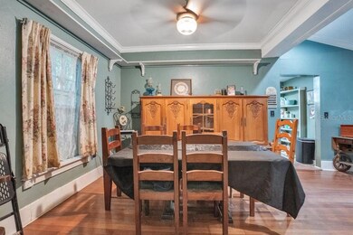 Featuring a tray ceiling and thoughtful display shelving, the designated Dining space combines sophistication with versatility.