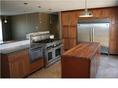 Remodeled kitchen has tile floors, granite counter