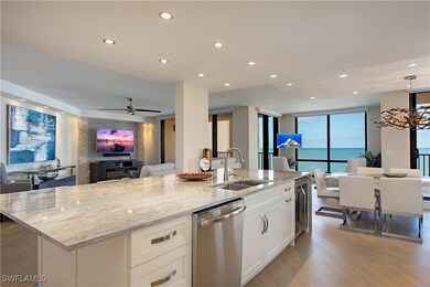 Kitchen featuring open floor plan, recessed lighting, stainless steel dishwasher, light stone counters, and light wood-type flooring