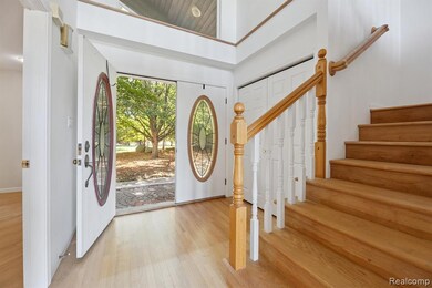 Foyer entrance with stairway and hardwood / wood-style floors
