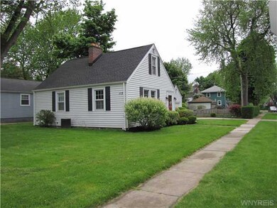 Exterior Front. Side yard facing Highland, drivewa