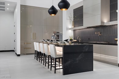 Kitchen featuring modern cabinets, stainless steel