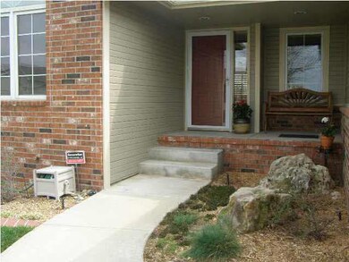 Front door with custom landscaped area.