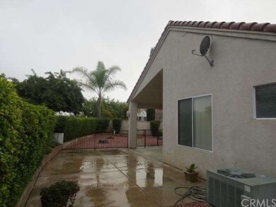 Rear of home looking toward covered patio with acc