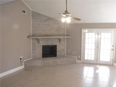 Den with fireplace, cathedral ceilings, and french