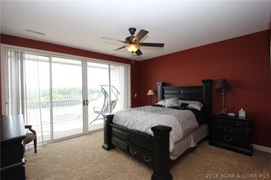 Master Bedroom with Slider to Screened Deck and Fa