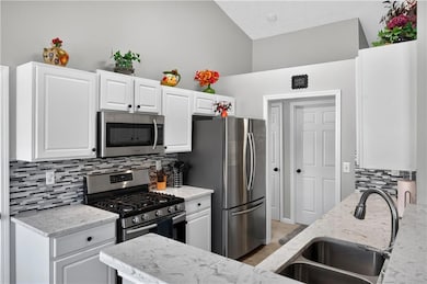 Granite, tile backsplash and stainless appliances