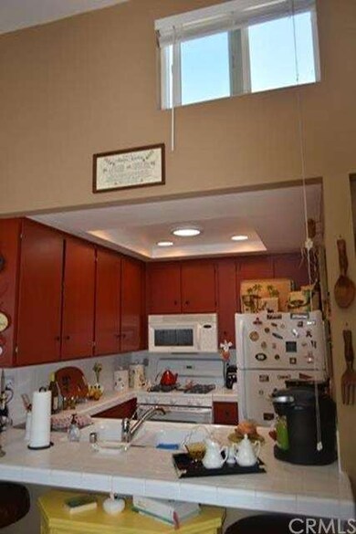 Kitchen features raised ceiling with can lights an